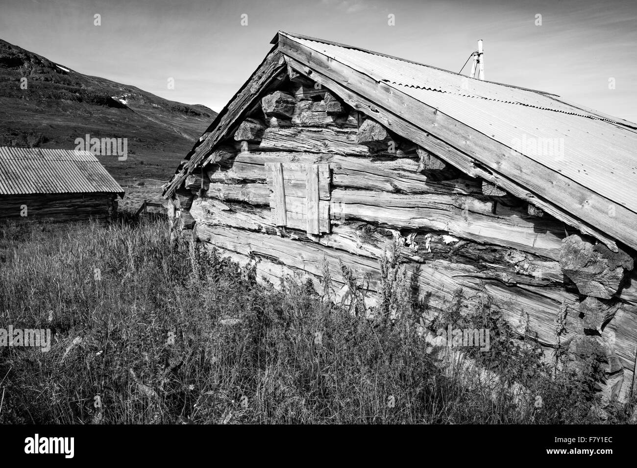 Ancient wooden log farm building with corrugated roof at Brimi in Oppland Norway Stock Photo