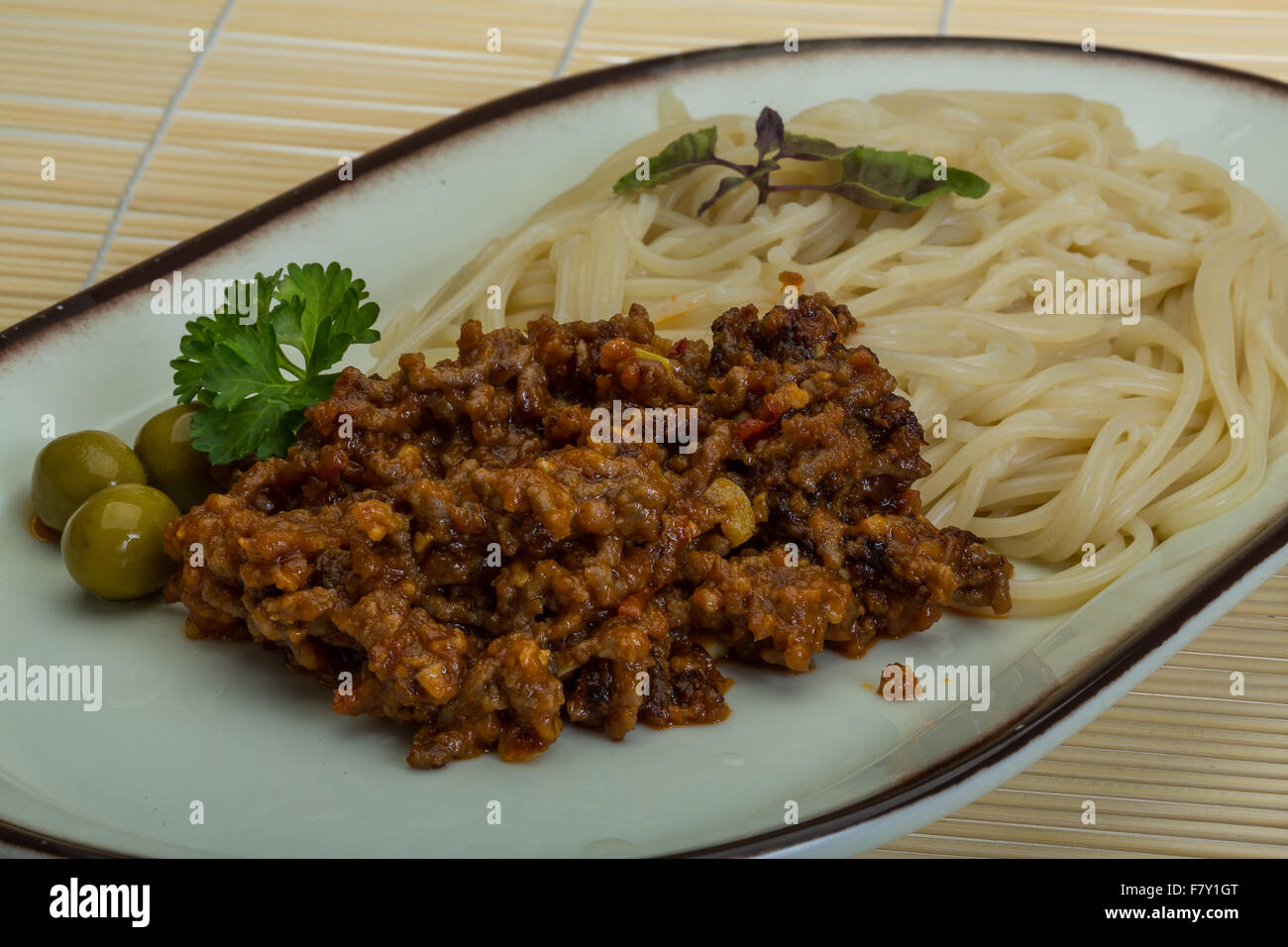 Spaghetti bolognese with olives, parsley and basil Stock Photo Alamy