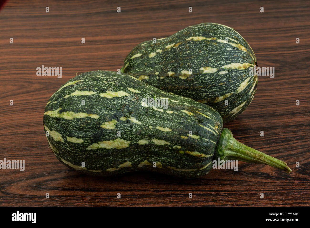 Two Green pumpkins on the wooden background Stock Photo - Alamy