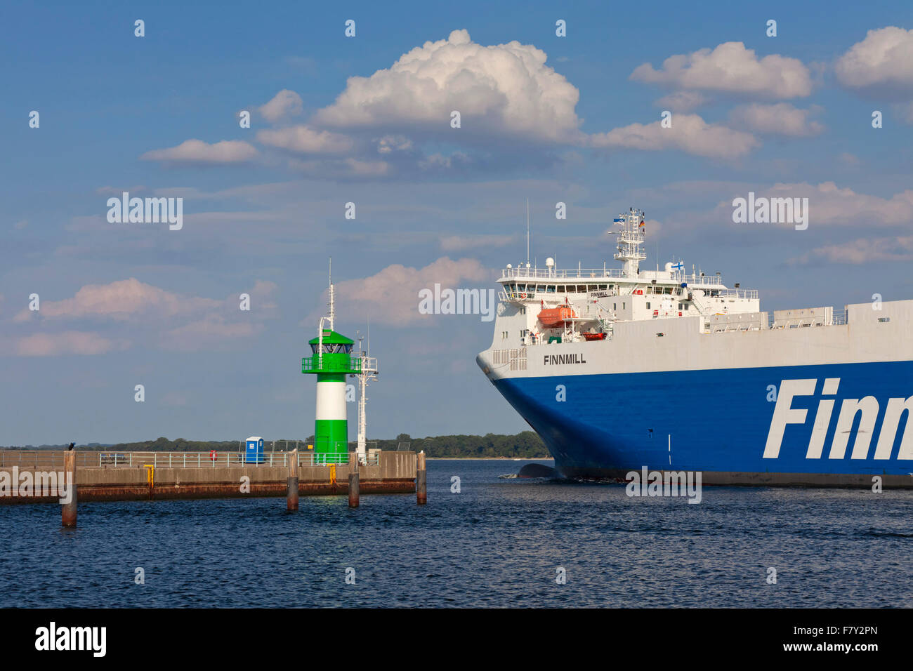 Ro-ro ferry Finnmill from Finnlines passing lighthouse Travemünde Nordmole / Nordmolefeuer, Travemuende, Lübec, Germany Stock Photo