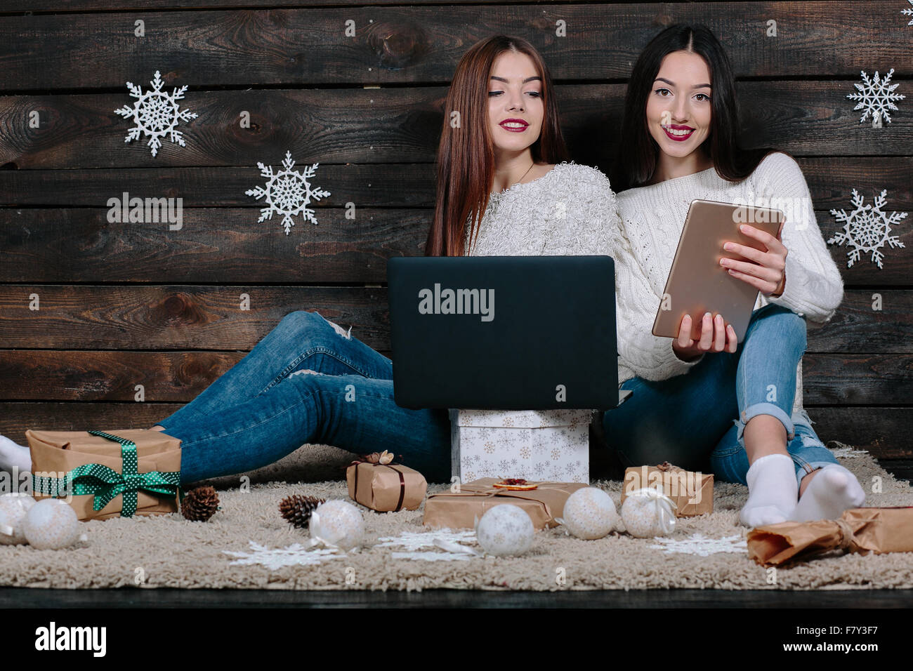 Two beautiful girls siting on the floor Stock Photo - Alamy