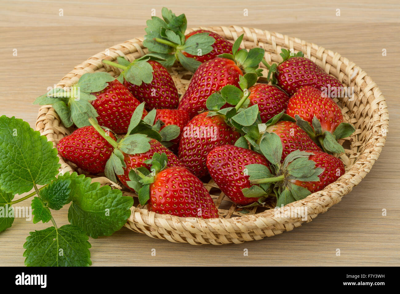 Fresh ripe strawberries in the bowl on wooden background Stock Photo ...