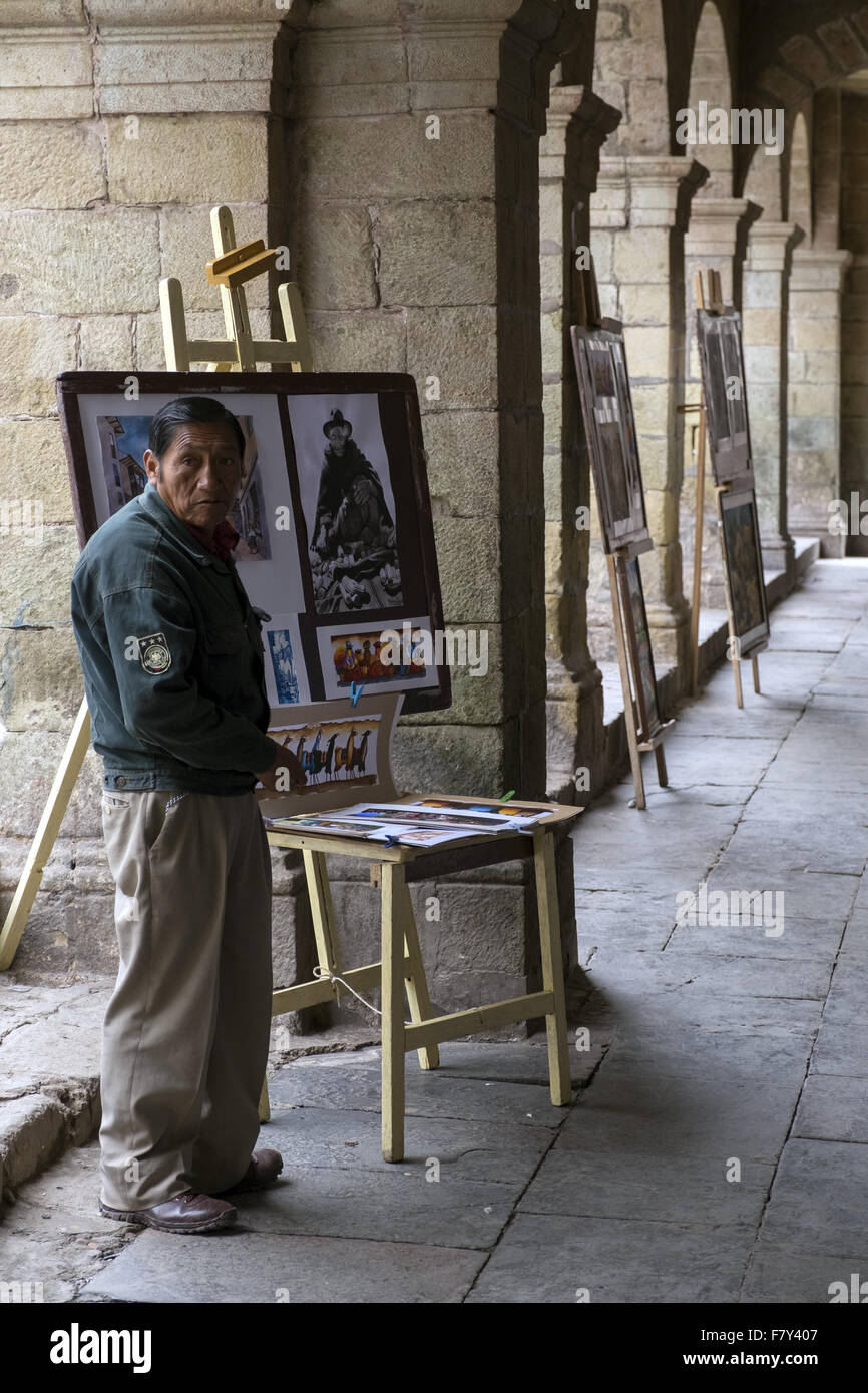 An artist selling his paintings with scenes of Andean origin Stock Photo