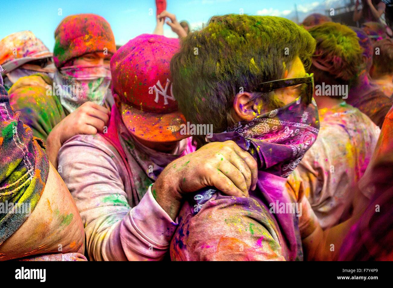 Crowds covered in colored powder bunch together during the Holi Festival of Colors at the Sri Sri Radha Krishna Temple March 30, 2013 in Spanish Fork, Utah. The festival follows the Indian tradition of Holi and attracts over 80,000 people. Stock Photo