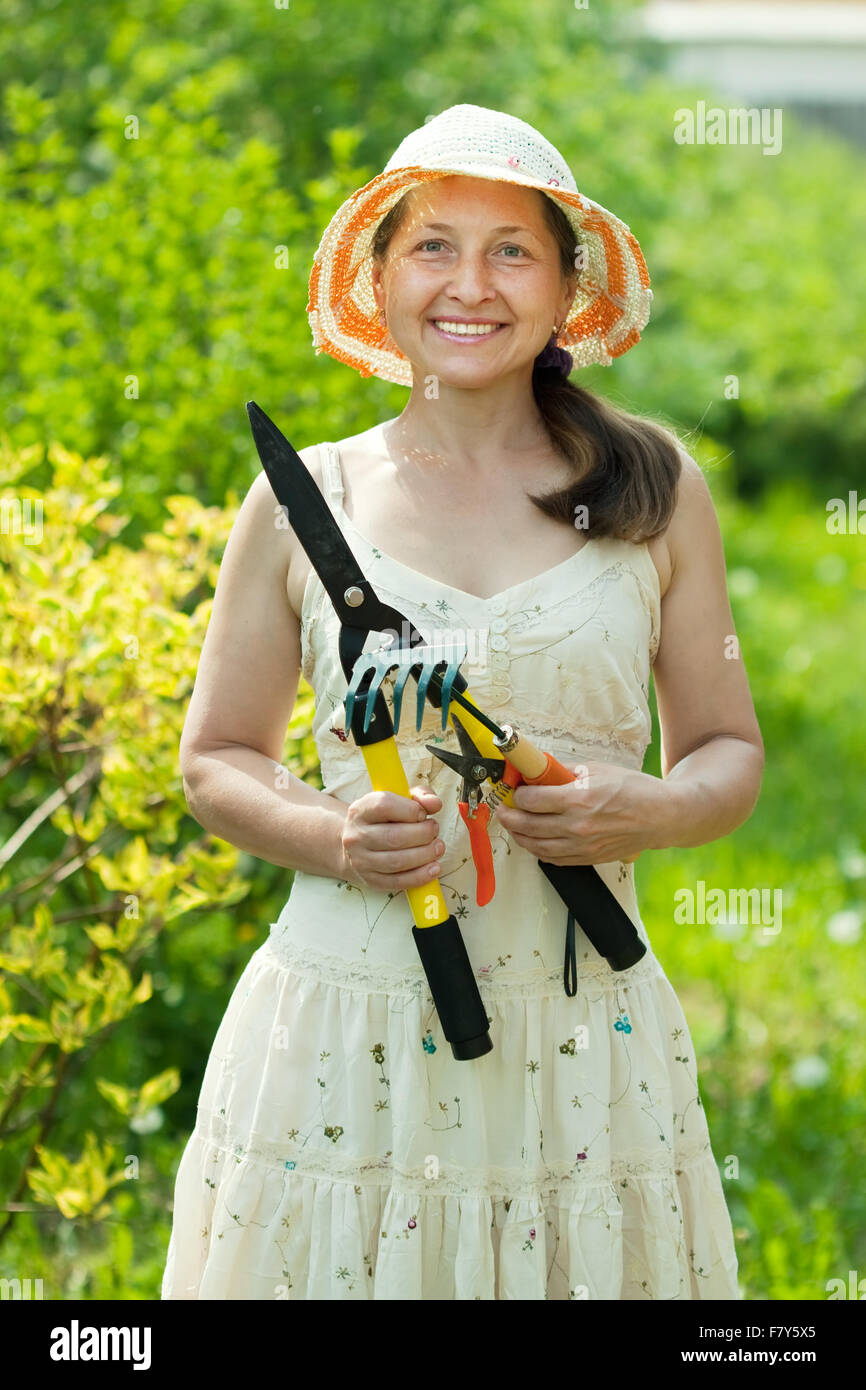 Happy mature woman gardening in yard Stock Photo - Alamy