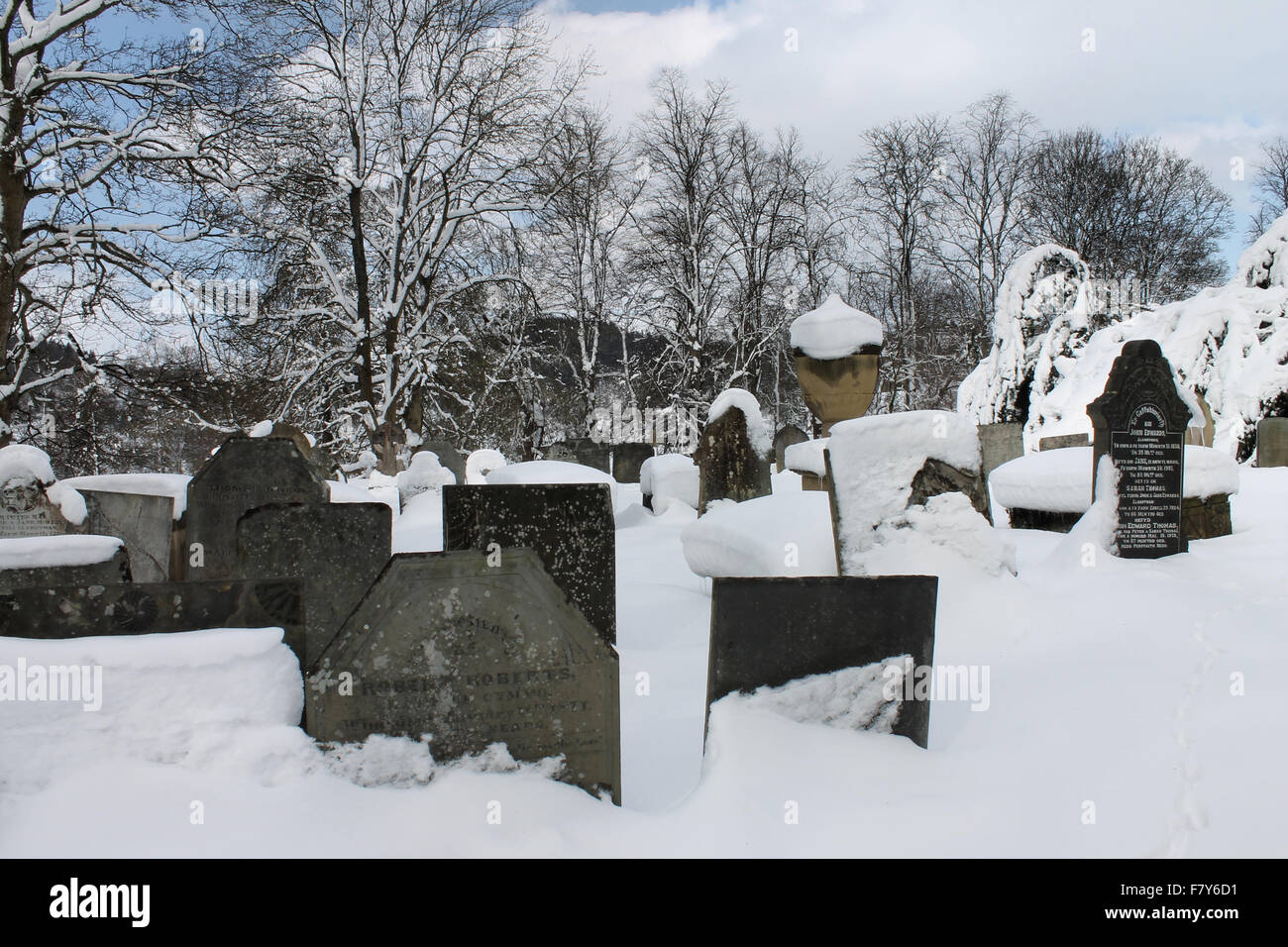 Llantysilio church graveyard gravestones and snow in winter Stock Photo