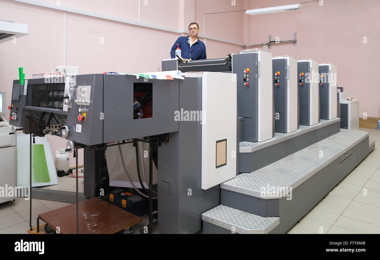 Printer working at his modern offset machine Stock Photo - Alamy