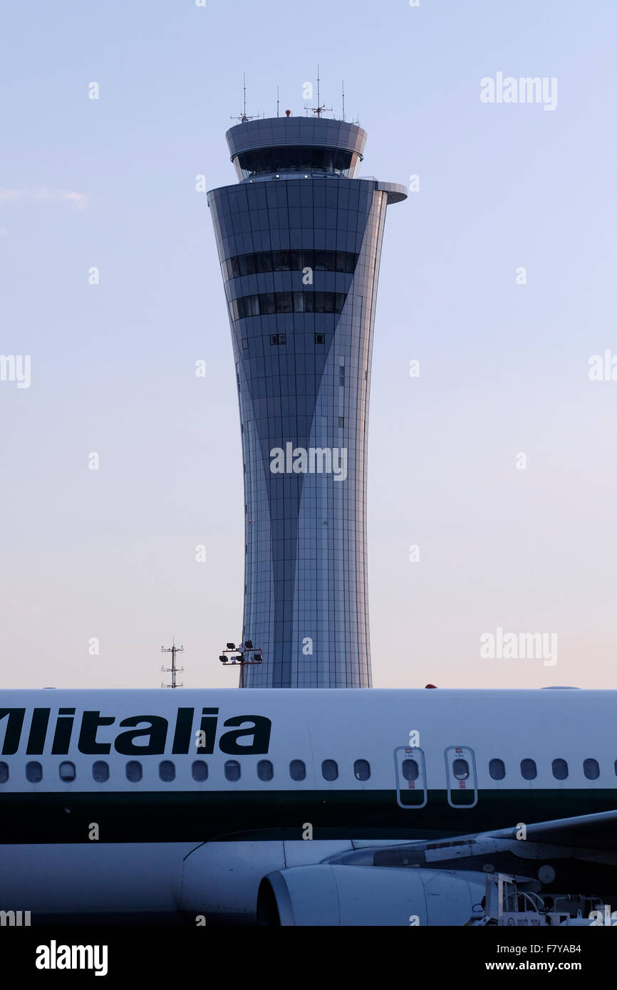 Air traffic control tower with Alitalia airlines airplane Stock Photo