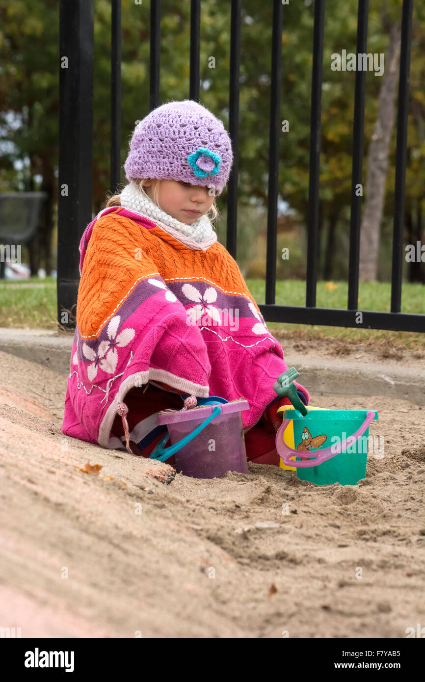 kid playing in a sandbox Stock Photo