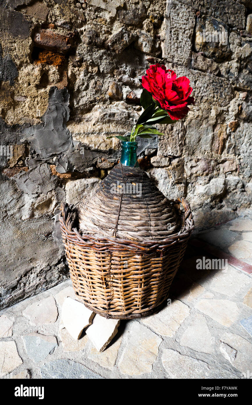 Bottle and rose in the town of Todi - Perugia, Italy Stock Photo