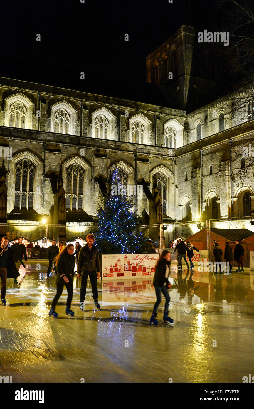 Skaters on the Ice Skating Rink in the grounds of Winchester Cathedral, Winchester, Hampshire UK where the annual Christmas Mark Stock Photo