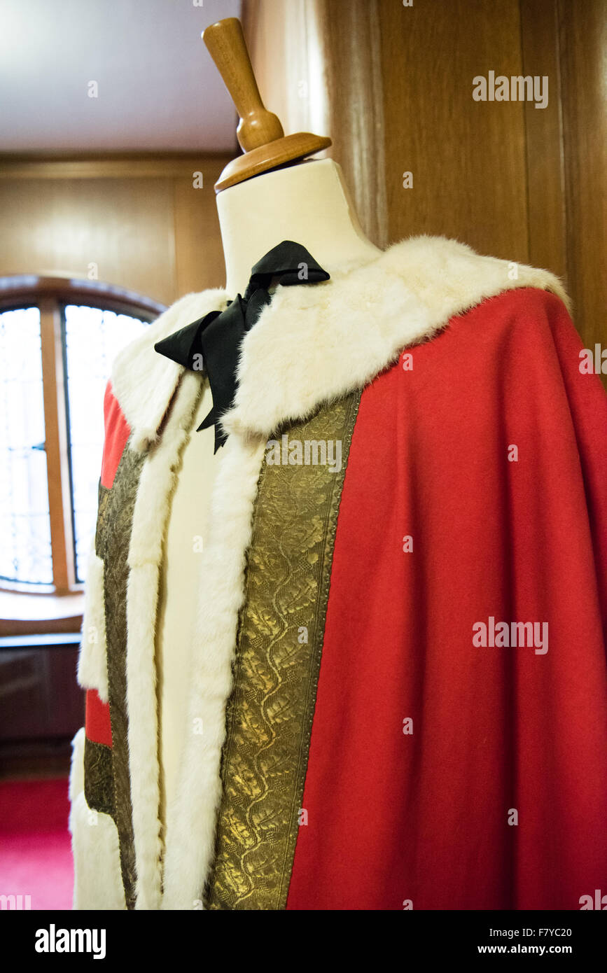 English civic mayoral red robe with ermine collar and gold brading on a