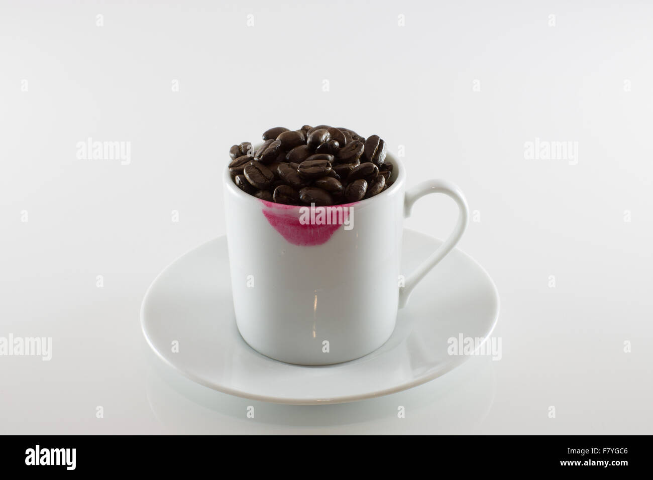 White cup and lipstick mark with coffee beans Stock Photo Alamy