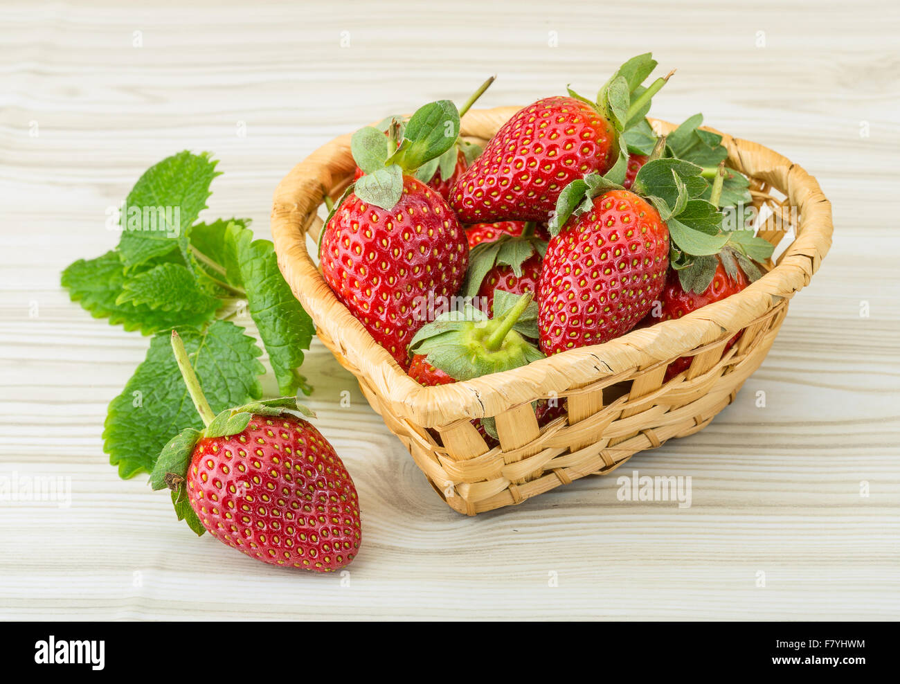 Fresh ripe strawberries in the bowl on wooden background Stock Photo ...