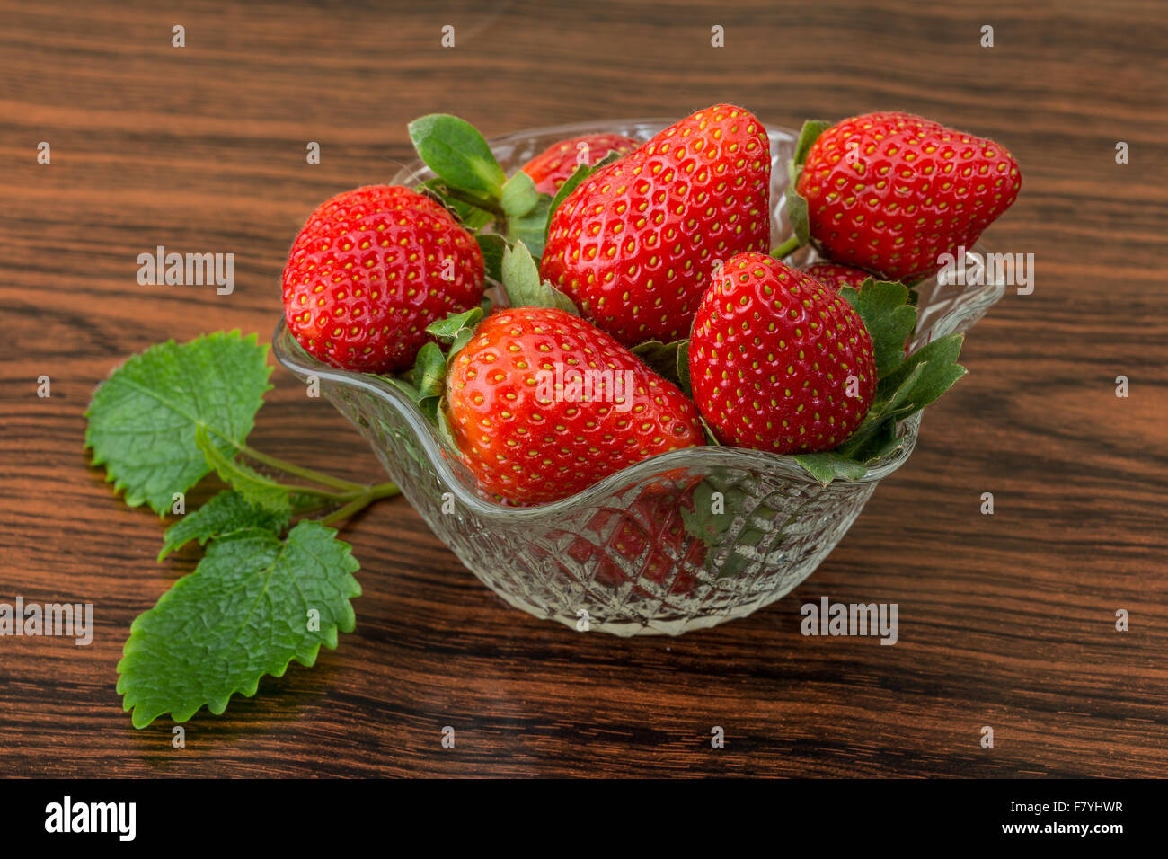 Fresh ripe strawberries in the bowl on wooden background Stock Photo ...
