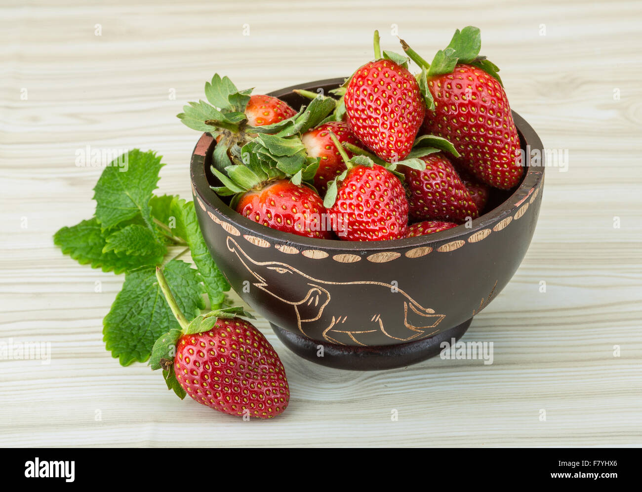 Fresh ripe strawberries in the bowl on wooden background Stock Photo ...