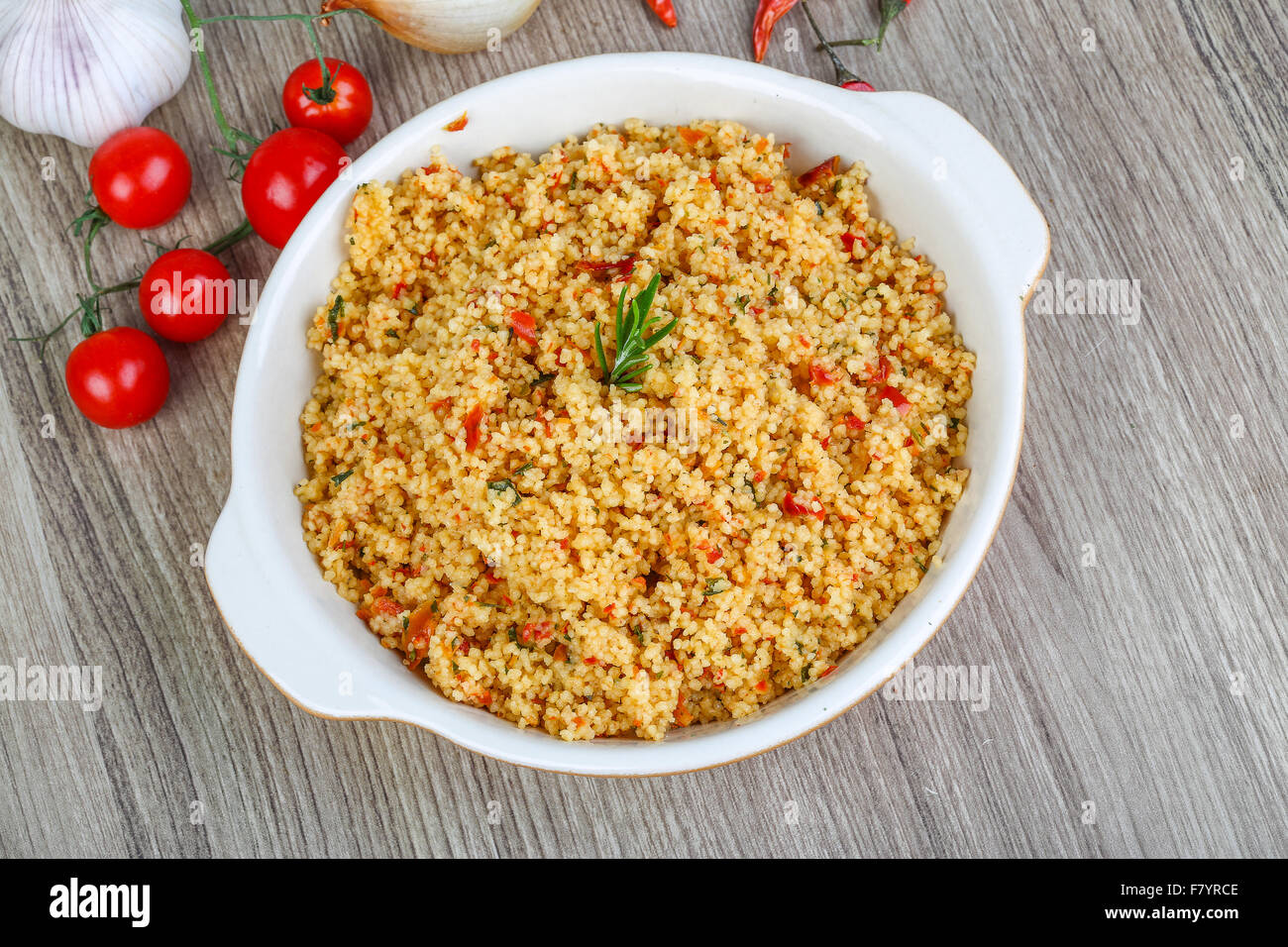 Arabic traditional cuisine Couscous with tomato and green onion Stock