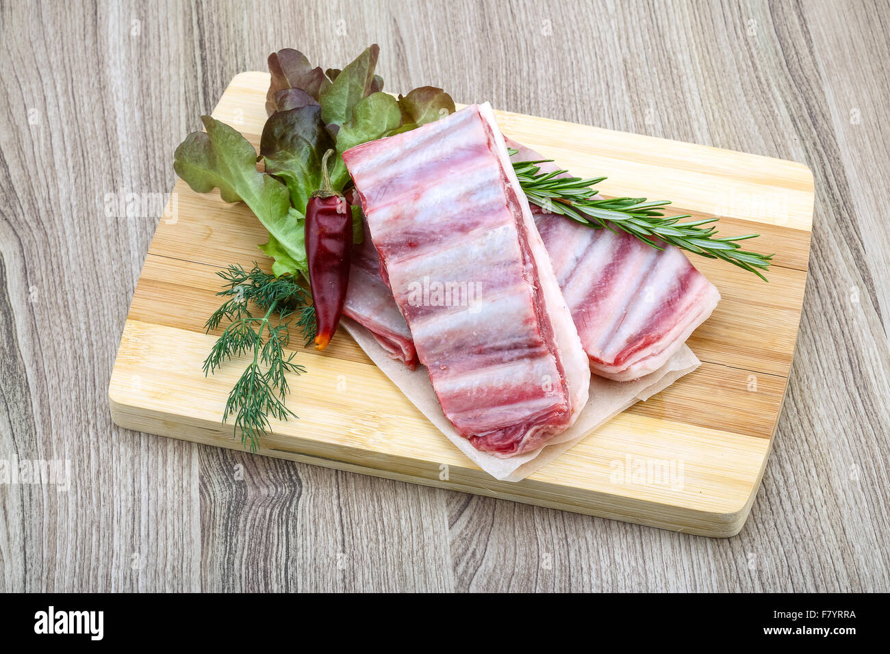 Fresh cold Raw lamb ribs with garlik and pepper - ready for cooking ...