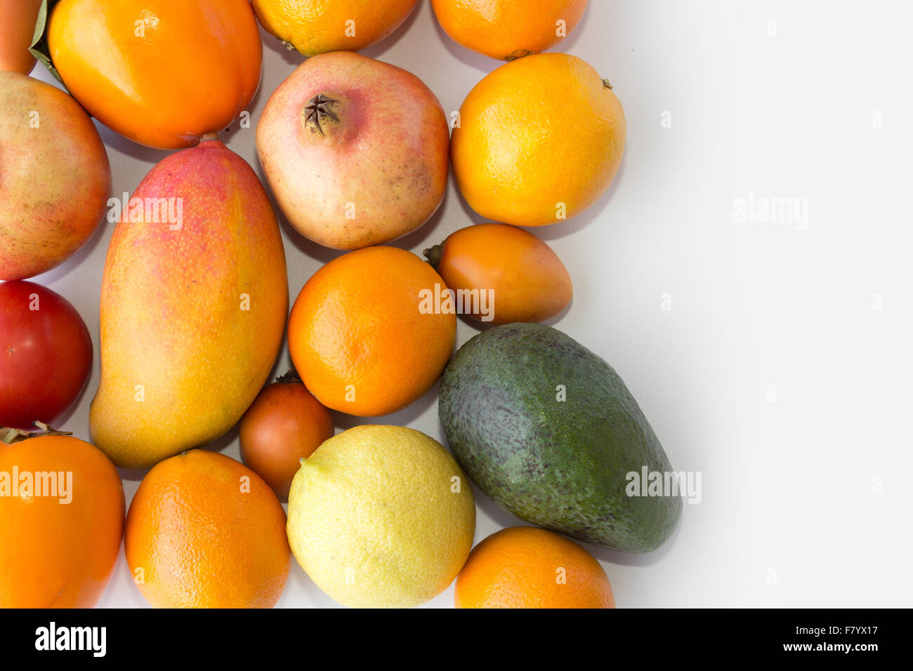 fruits and vegetables closeup - food macro / closeup of oranges, avocado, mango, tomato, kaki, apple, Stock Photo