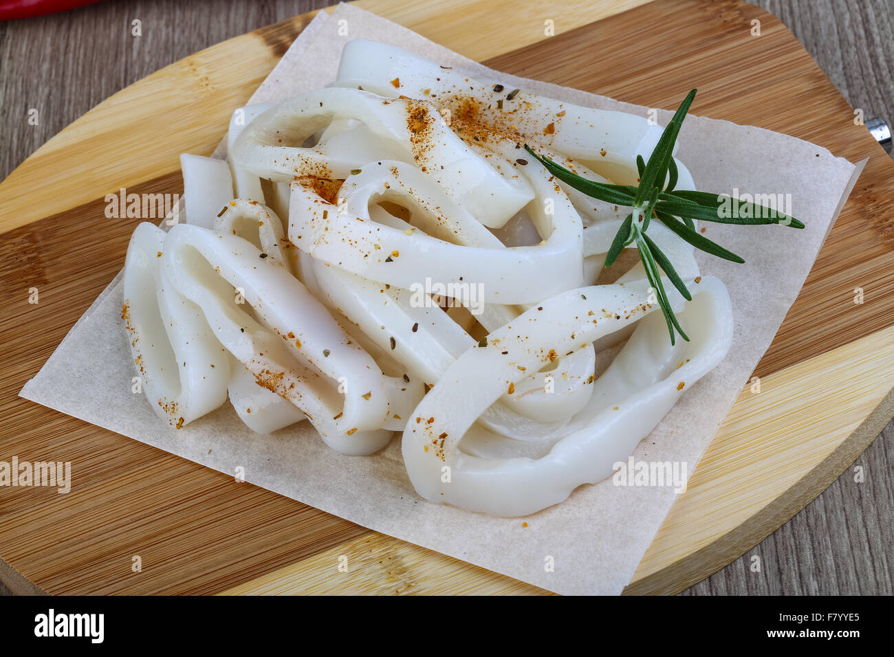 Raw squid rings with herbs - ready for cooking Stock Photo - Alamy