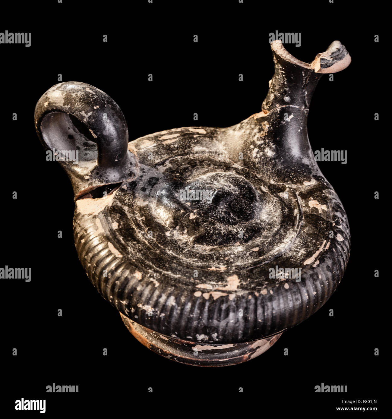 an ancient Daunian venusian Oil Lamp or lucerna isolated over a black background Stock Photo