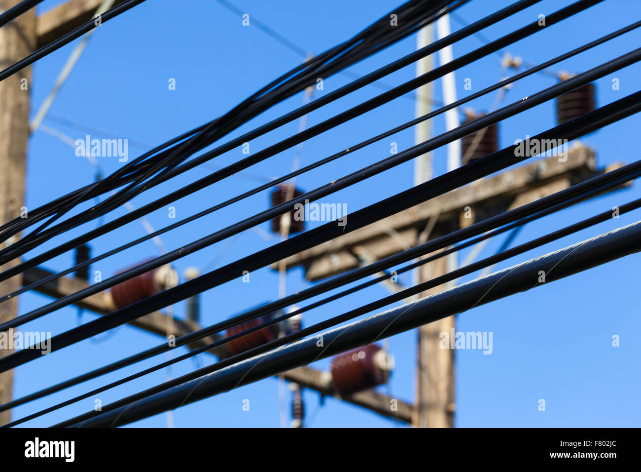 close up shot of some high voltage electricity cables over the blue sky