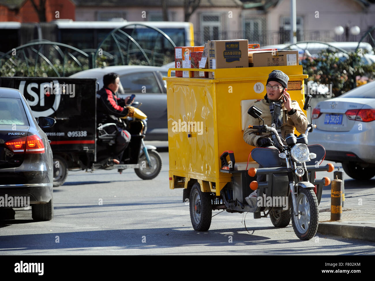 Two express-delivery electric tricycles shuttle in the streets in Beijing, China. 2015 Stock Photo