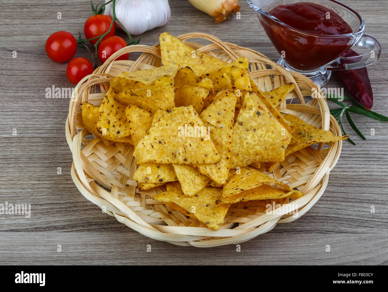 Nachos chips with tomato hot sauce on the wood background Stock Photo ...