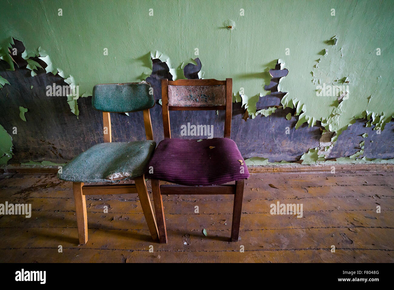 Two wooden chairs in an abandoned prison in Tallinn Stock Photo