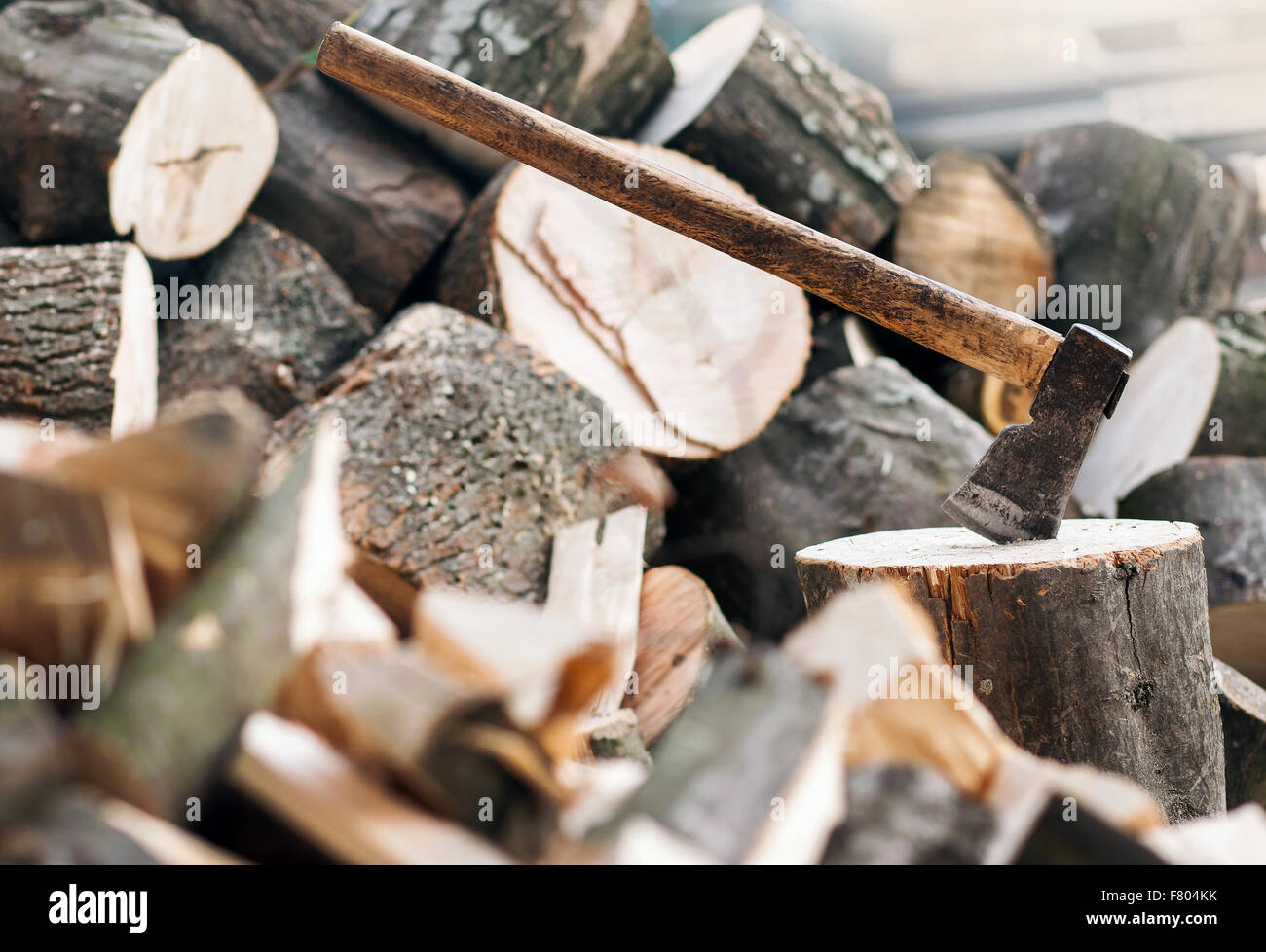 Axe stuck in a stump Stock Photo