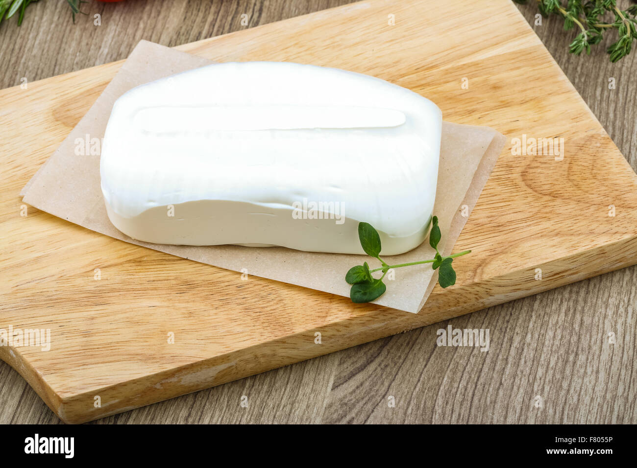 Traditional Greek cheese - Feta with herbs on the wood background Stock ...