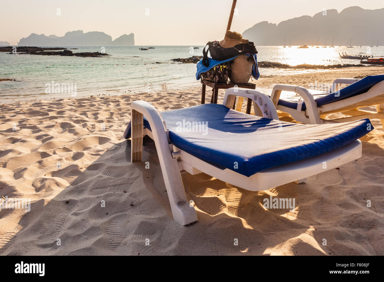 a plastic chaise lounge on a tropical beach on sunset in Phi Phi Island, Thailand Stock Photo