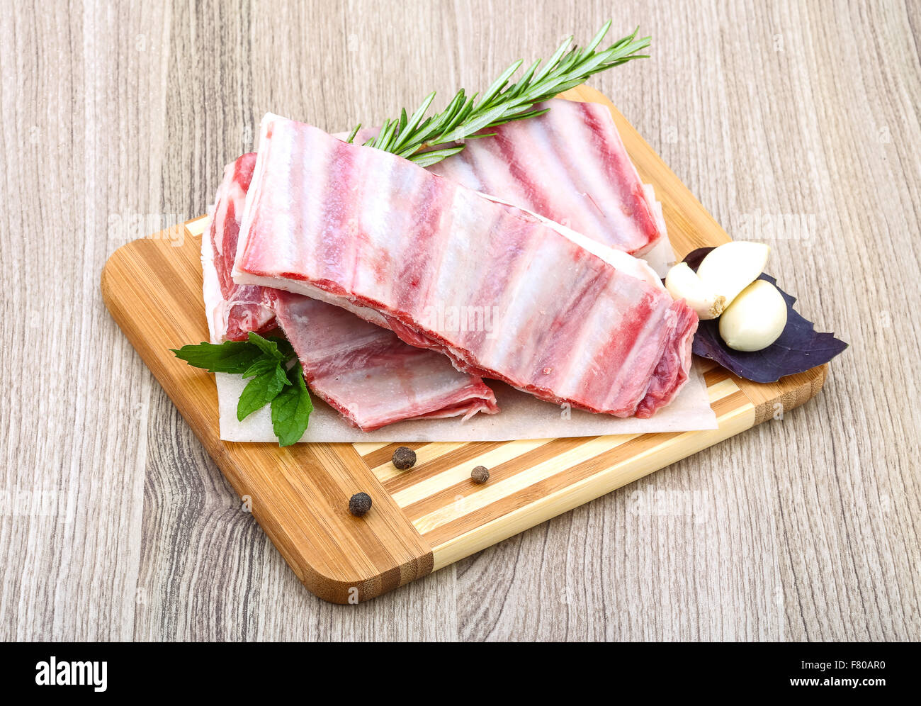 Fresh cold Raw lamb ribs with garlik and pepper - ready for cooking ...