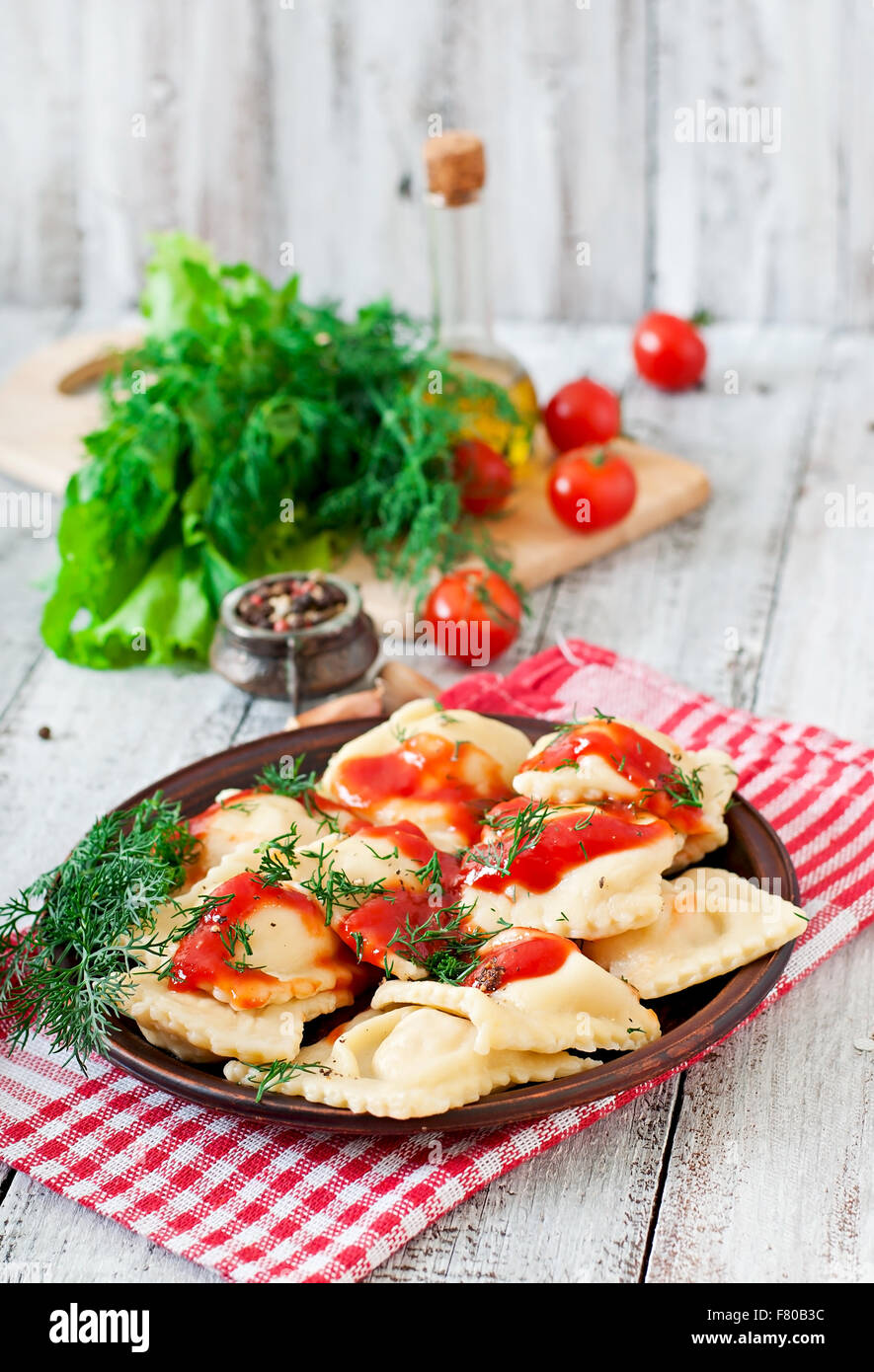 Delicious ravioli with tomato sauce and dill Stock Photo - Alamy