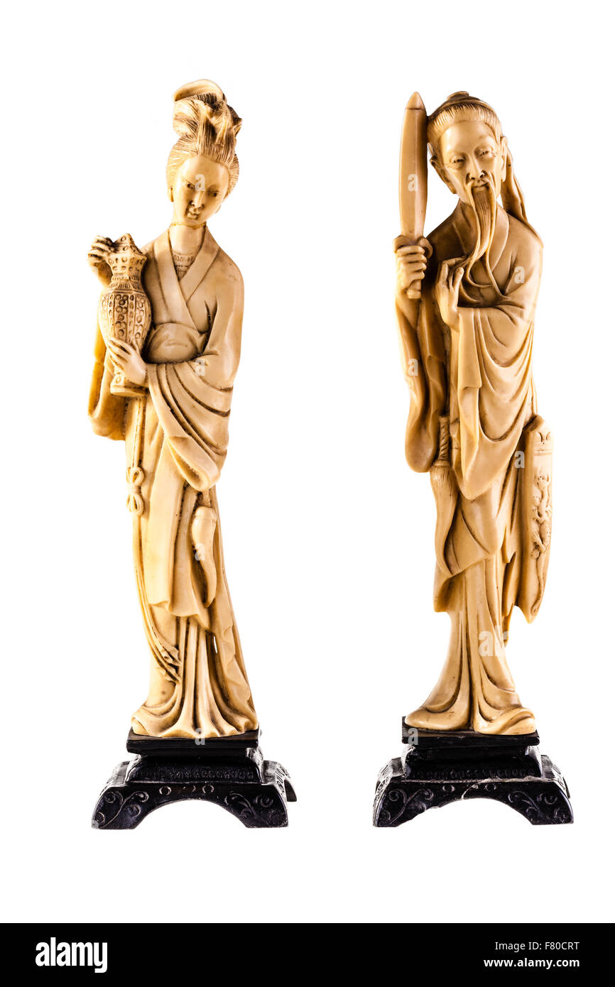 a couple of ancient chinese statuette isolated over a white background Stock Photo