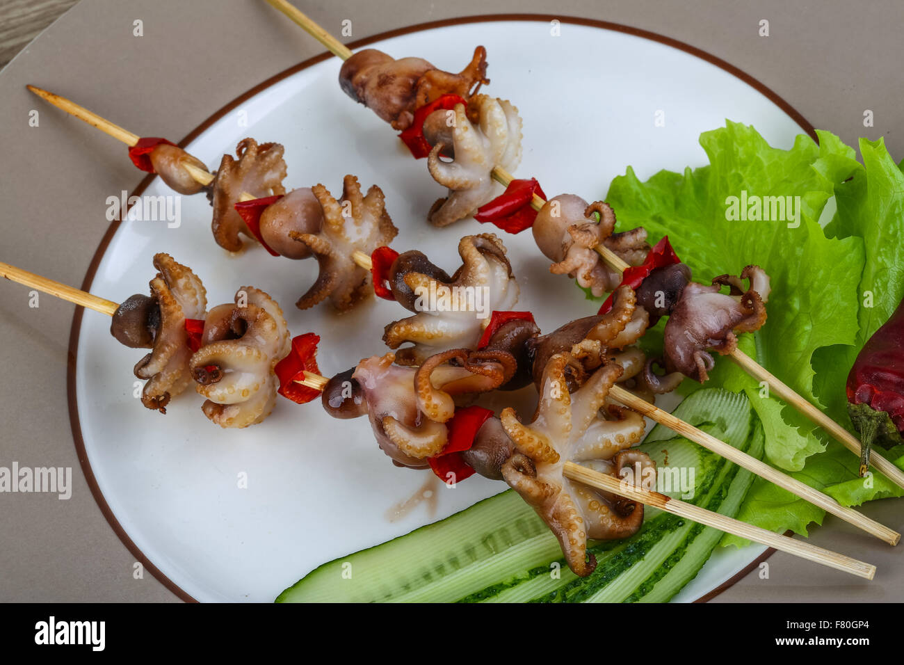 Grilled octopus skewers with red pepper and onion Stock Photo Alamy