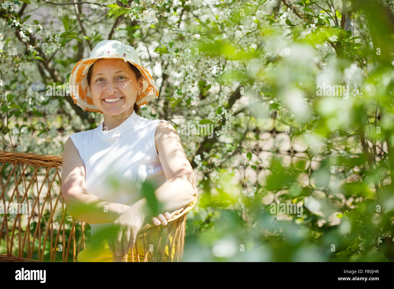 Happy mature woman relaxing in blossoming garden Stock Photo - Alamy