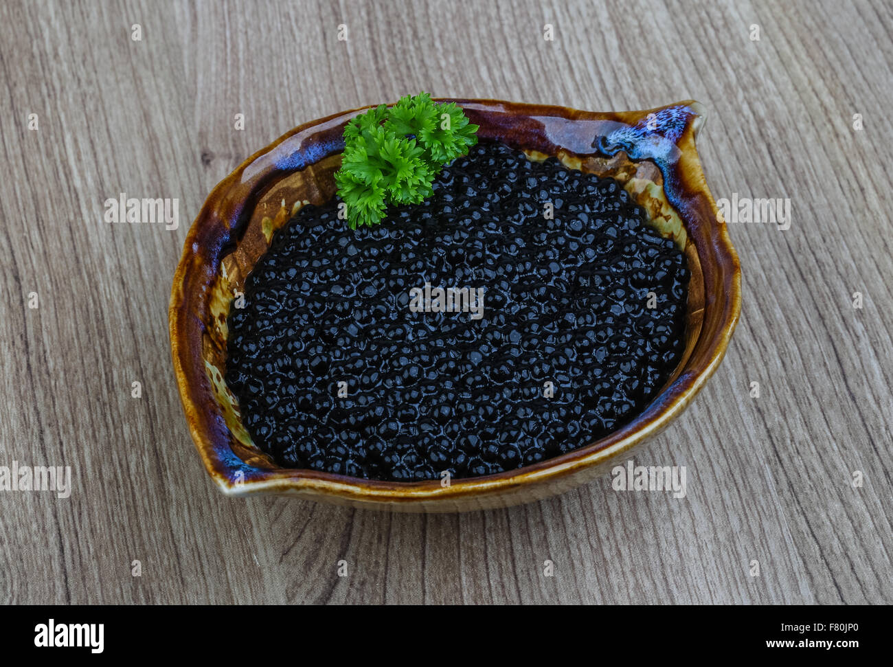 Luxury Black caviar in the bowl with parsley leaves Stock Photo Alamy