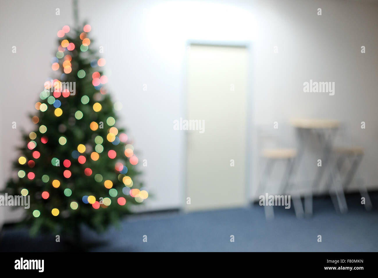 Blurred background image of an office decorated with bokeh of christmas tree, to be used for background purpose Stock Photo