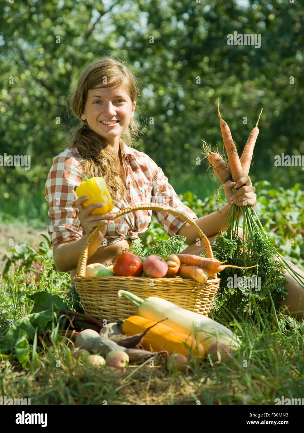 Teenage girl with basket of harvested vegetables Stock Photo - Alamy
