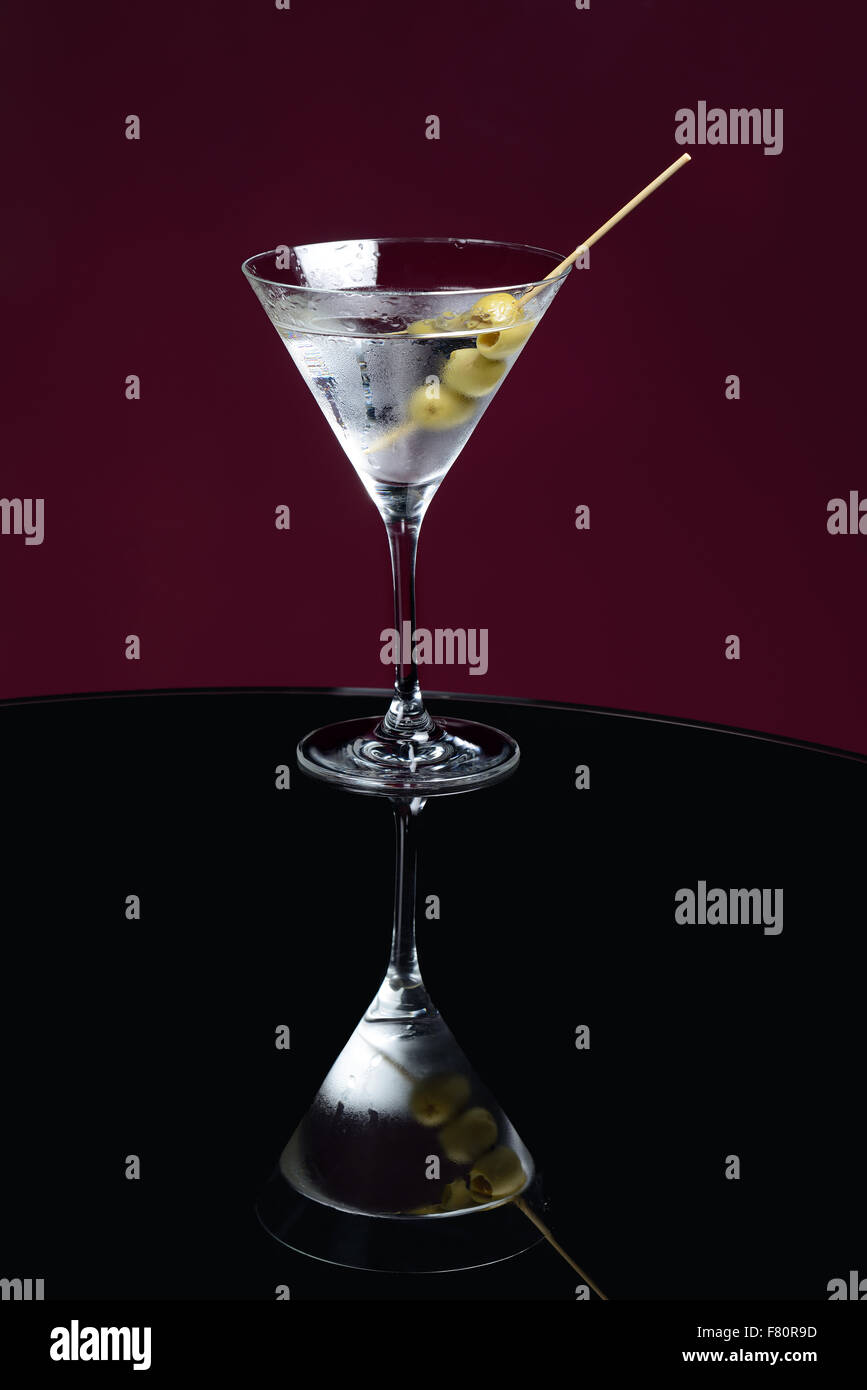 martini cocktail on the table with olives Stock Photo