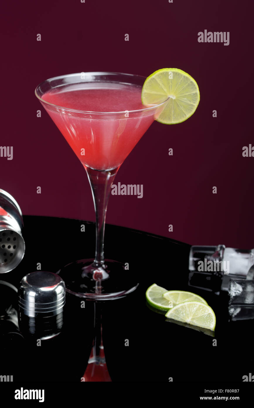 Red cocktail cosmo cosmopolitan martini glass barman hires stock