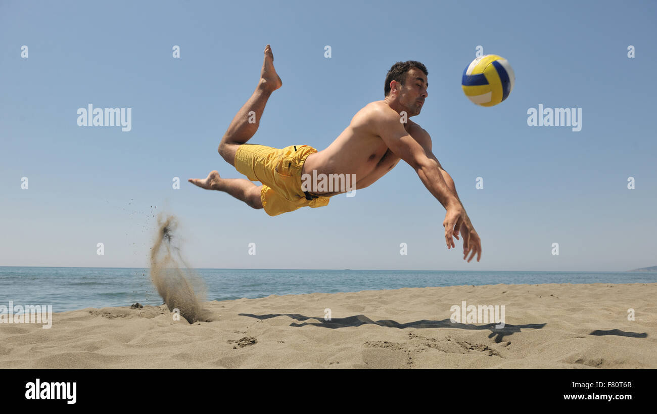 male beach volleyball game player jump on hot sand Stock Photo - Alamy