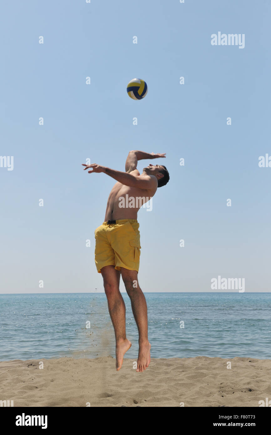 male beach volleyball game player jump on hot sand Stock Photo - Alamy