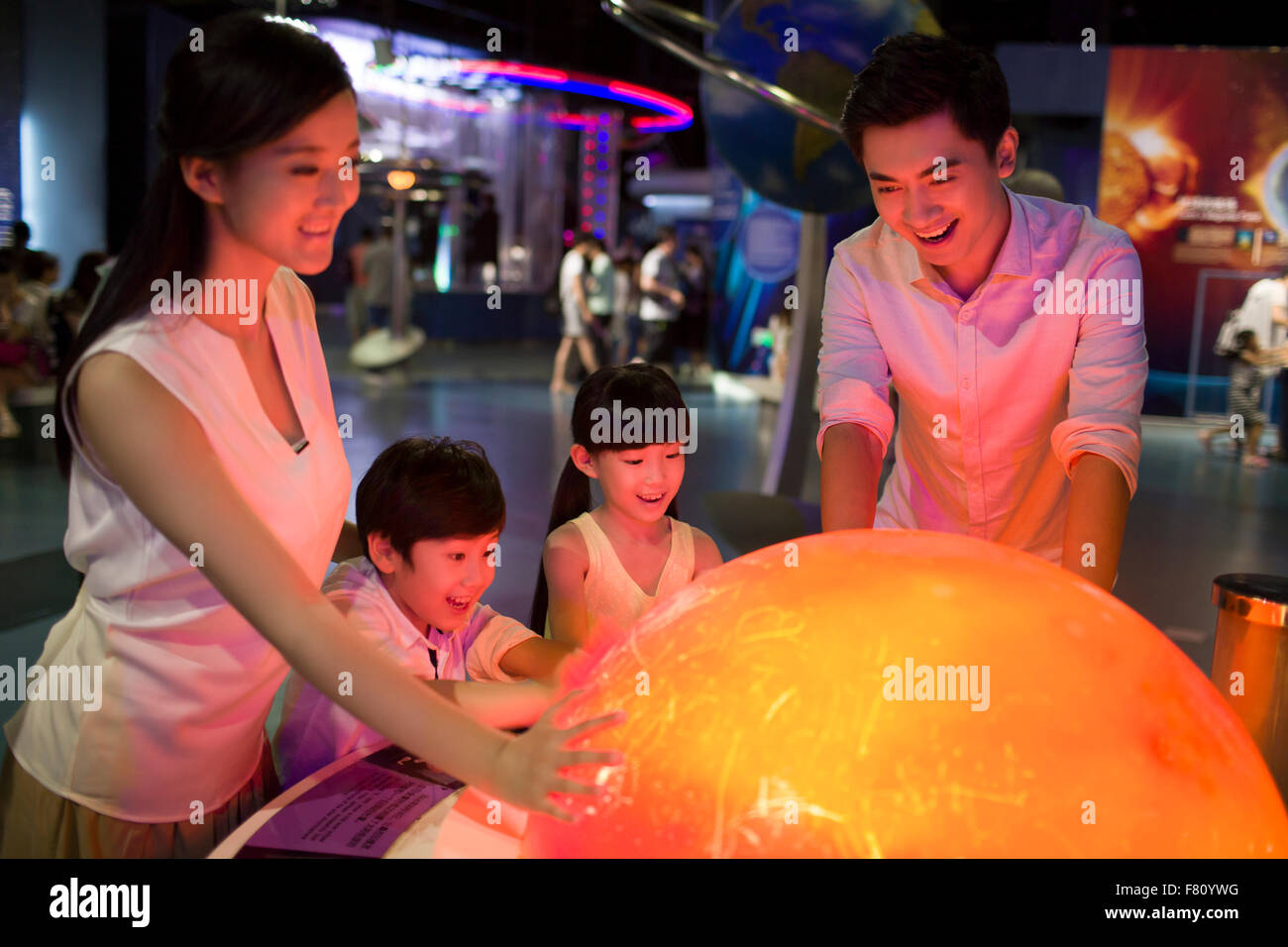 Young family in science and technology museum Stock Photo