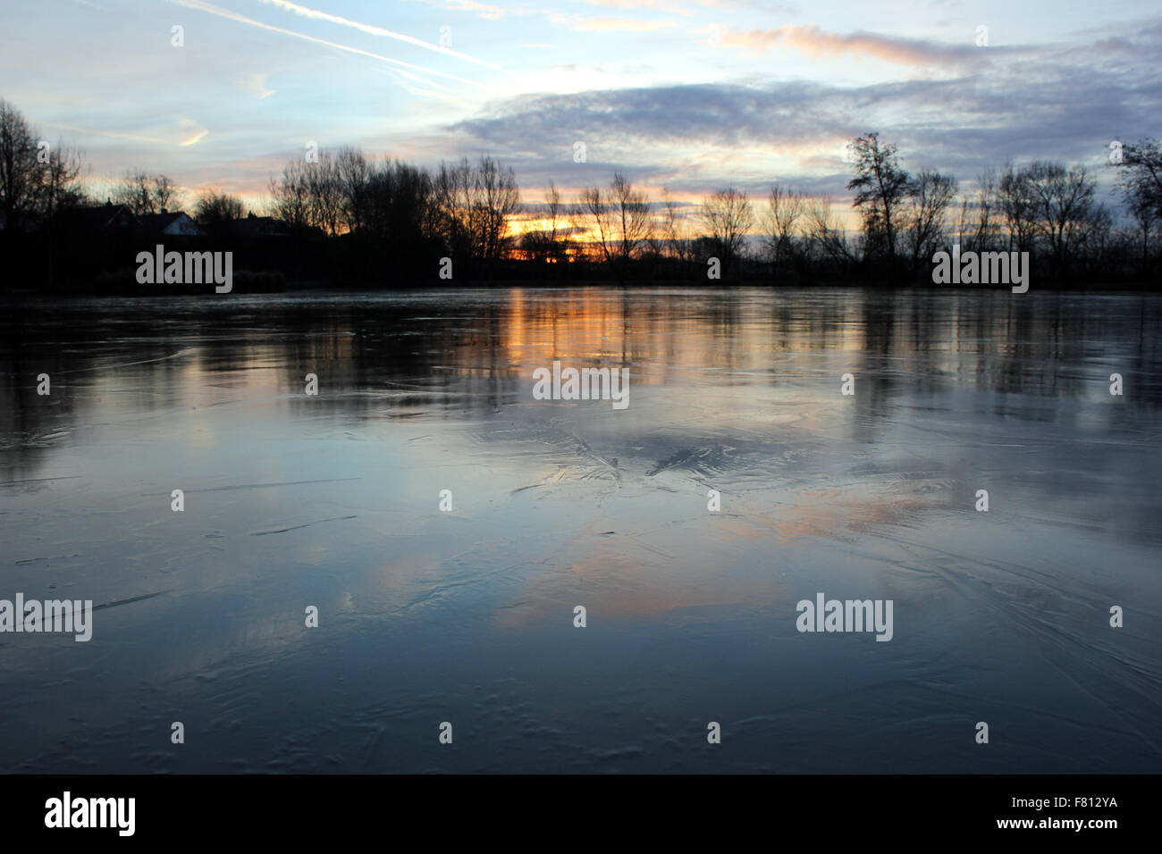 Icy dawn over a frozen fishing lake near Burscough in West Lancashire
