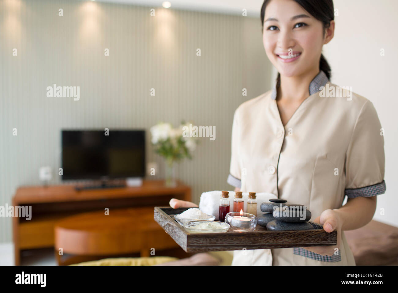 Massage therapist holding massage supplies Stock Photo Alamy