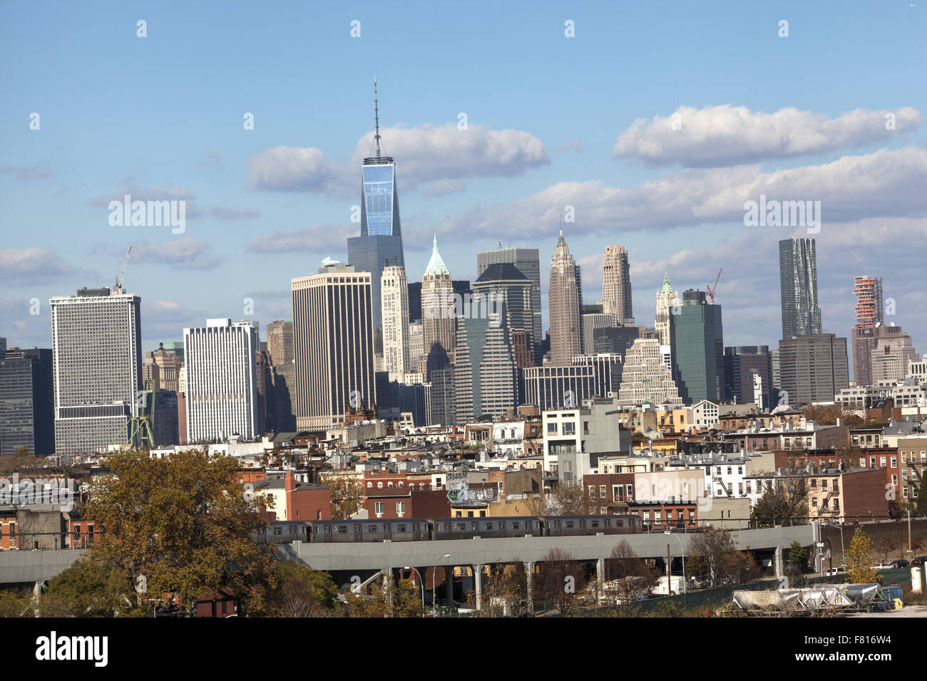 Looking across residential neighborhoods in Brooklyn with the lower Manhattan skyline looming up behind. NYC Stock Photo