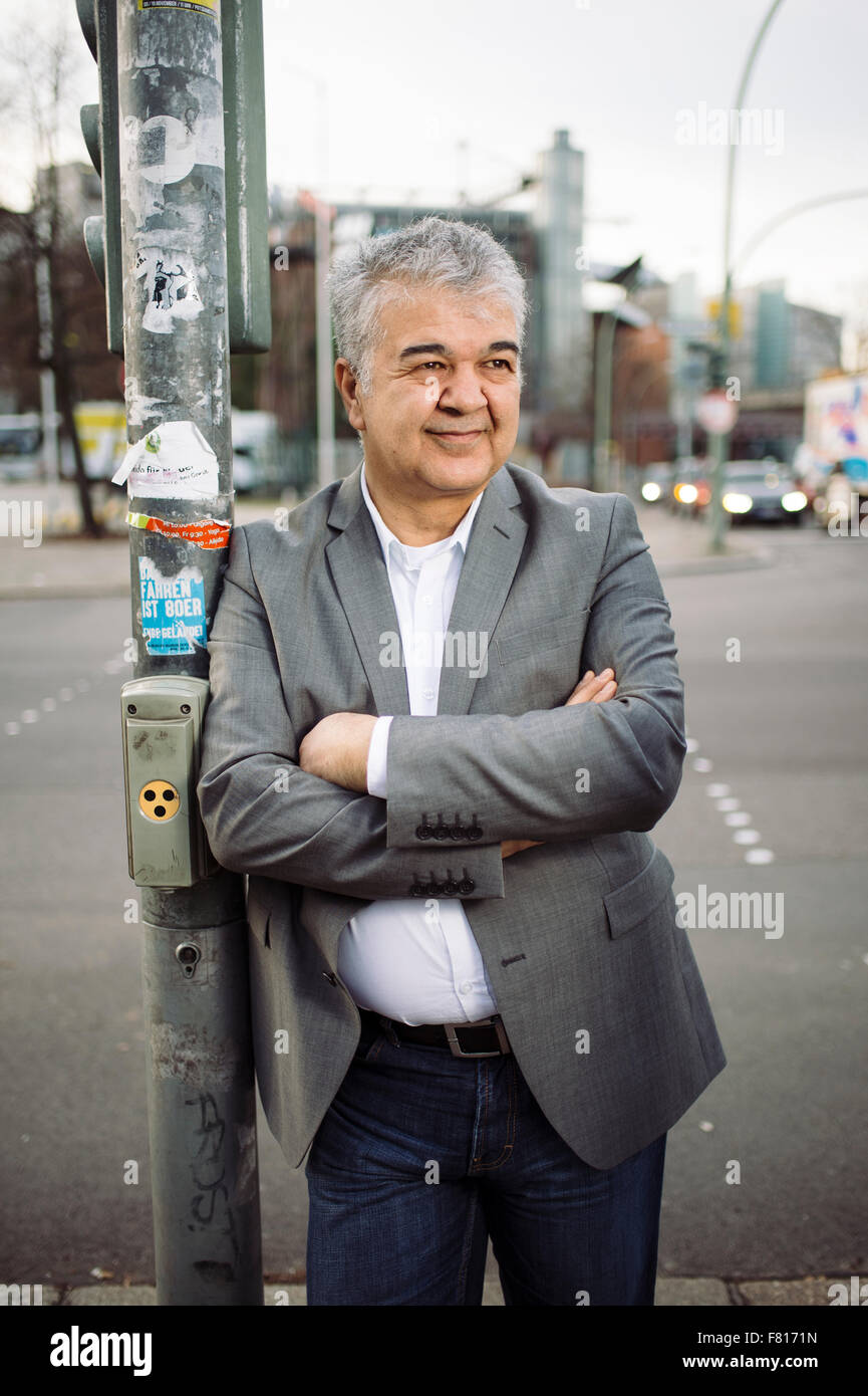 Berlin, Germany. 03rd Dec, 2015. Federal chairman of the Turkish Community in Germany (TGD), Goekay Sofuoglu, leans against a traffic light at a crossroads in Berlin, Germany, 03 December 2015. Photo: Gregor Fischer/dpa/Alamy Live News Stock Photo