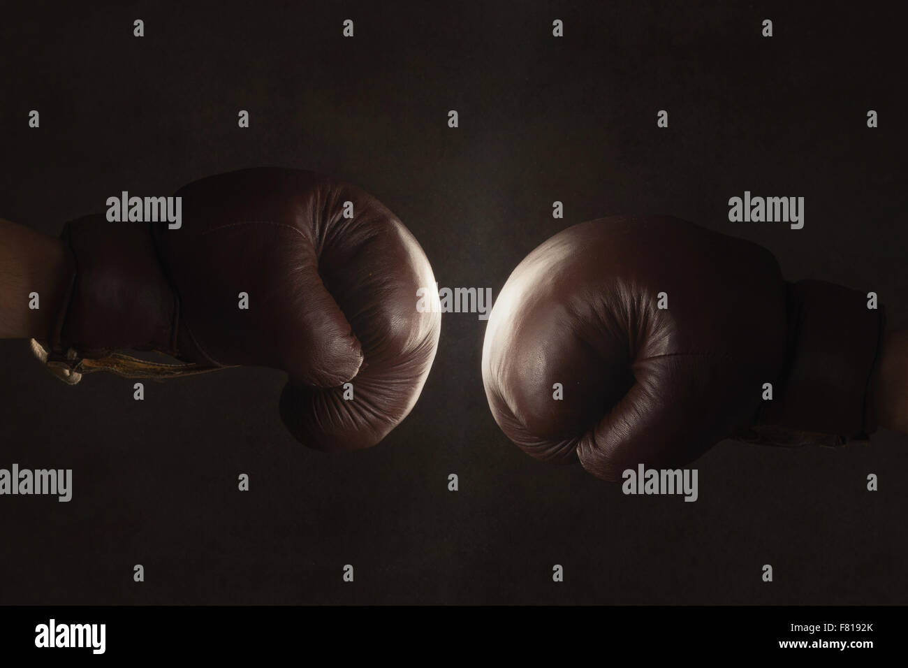 Two brown old boxing gloves hit together Stock Photo Alamy